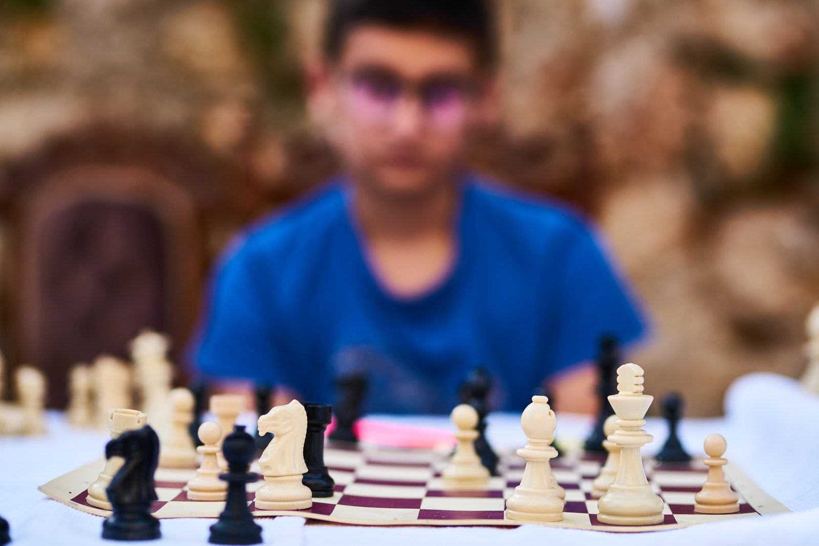 Child thinking of strategy and playing chess